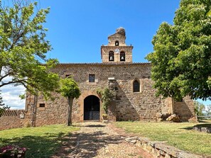 A historic stone building with a bell tower, arched entrance, and a paved pathway leading to the door. - Rural House 'Mila' with Mountain Views, Private Terrace and Wi-Fi (Tera)