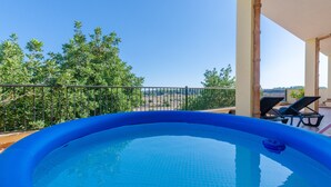 A swimming pool with a view of trees and a distant landscape. - Holiday Home 'Can Nadal - Adults Only' with Mountain View, Wi-Fi and Air Conditioning (Sineu)