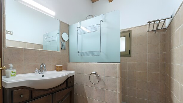 A bathroom with a sink, mirror, towel rack, and tiled walls. - Country House 'Cati Ref 57' with Private Pool, Wi-Fi and Air Conditioning (Son Servera)