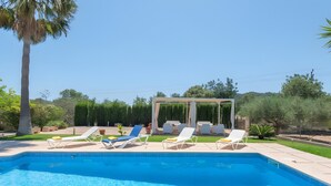 A swimming pool with lounge chairs and a pergola. - Country House 'Cati Ref 57' with Private Pool, Wi-Fi and Air Conditioning (Son Servera)