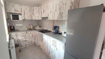 Fridge, microwave, stovetop, coffee/tea maker