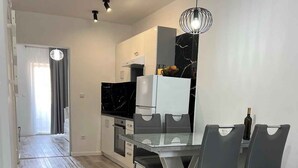 Eine moderne Küche mit Essbereich, einer Couch und einer Blumenvase.