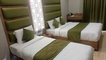 Deluxe Triple Room, 1 Bedroom | Desk, laptop workspace, iron/ironing board, free WiFi