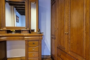 A wooden vanity with a mirror, a small vase, and a pair of shoes. - 38A01  Casa El Canton (Riosa)