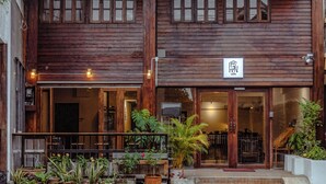 A wooden building with a sign reading "EIN" and a balcony with potted plants. - EAIN (Chiang Mai)