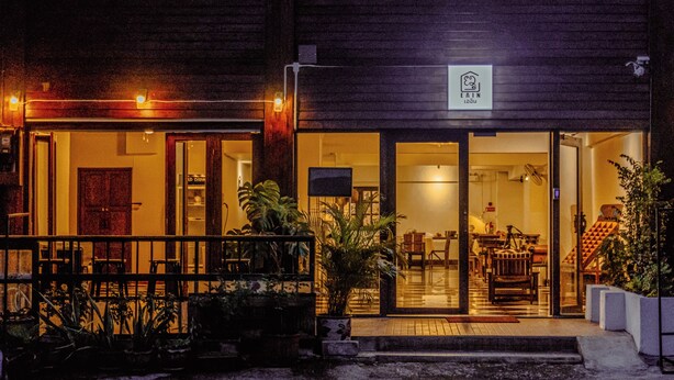 A building with a wooden facade, a visible entrance, and a sign above the door. - EAIN (Chiang Mai)