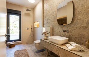 A modern bathroom with a large mirror, a glass sink, and a shower. - Cozy home in Donji Prolozac with sauna (Donji Prolozac)