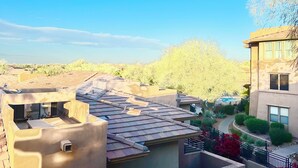 A residential area with multiple buildings, including a two-story house with a flat roof and a balcony. - Large 3 Bedroom in Central Scottsdale w/ Pool, Clubhouse, Fitness Room and More… (Scottsdale)