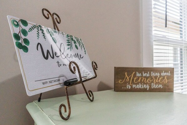 A sign with 'Welcome to our WiFi Network' and a wooden sign saying 'The best thing about Memories is making them.'