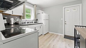 A modern kitchen with a built-in oven, a sink, and a refrigerator.