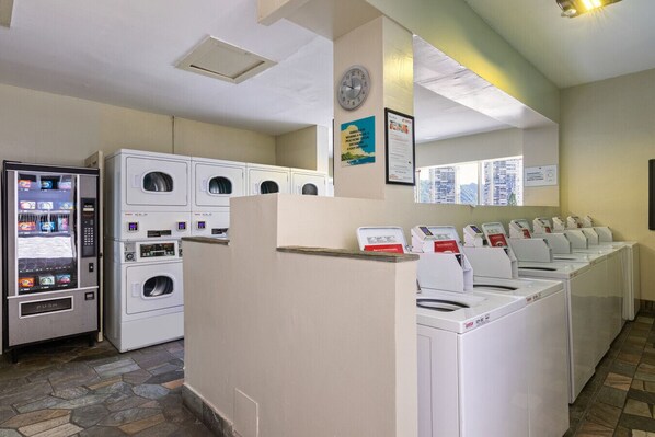 A laundry facility with multiple washing machines and a self-service laundry machine.