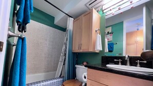 A bathroom with a bathtub, toilet, and sink.