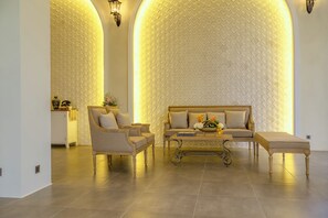 A spacious living area with a sofa set, a coffee table, and a side table. - Stone Age Boutique  (Kampot)