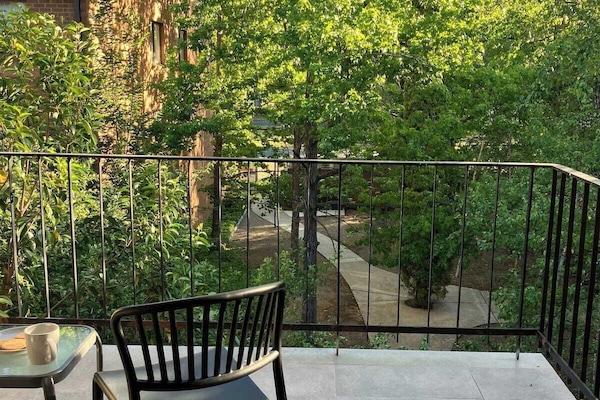 Chill balcony overlooking complex garden.