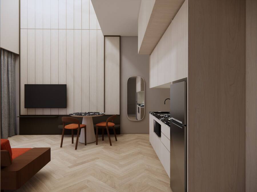 A modern kitchen with a built-in stove, a dining area with a round table and two chairs, and a large mirror on the wall.