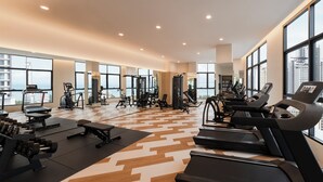 A modern gym with treadmills, weight machines, and a patterned floor. - Citadines Tanjung Tokong Penang (George Town)