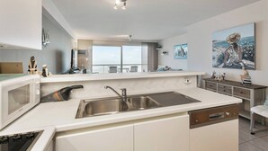 A modern kitchen with a built-in microwave, Bosch dishwasher, and stainless steel sink. - Apartment in Blankenberge by the Beach (BLANKENBERGE)