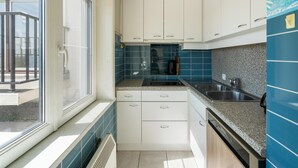 A modern kitchen with white cabinets, a granite countertop, and a stainless steel sink. - Flat in Bruges with Panoramic City Views (BLANKENBERGE)
