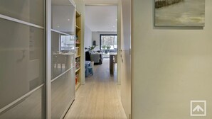A modern interior with a hallway leading to a living area.