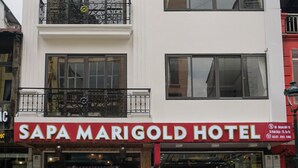 A multi-story building with a sign for Sapa Marigold Hotel. - SaPa Marigold Hotel (Sa Pa)