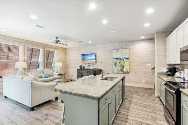 Signature House, 2 Bedrooms, Balcony, Garden View | Living room | 65-inch Smart TV with cable channels