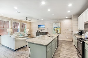 Signature House, 2 Bedrooms, Balcony, Garden View | Living room | 65-inch Smart TV with cable channels