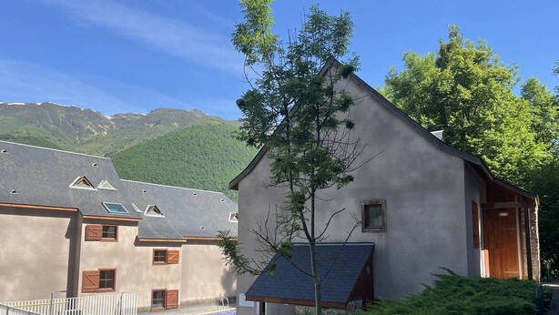 A building with a sloped roof, a small window, and a door. - Studio in Cauterets with pool and pets allowed (Cauterets)