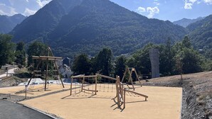 A playground with wooden climbing structures and swings, set against a backdrop of mountains and trees. - Studio in Cauterets with pool and pets allowed (Cauterets)