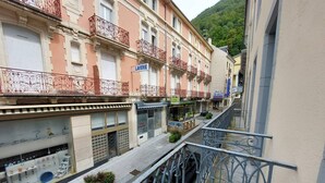 A street view with a row of buildings, including a shop with a sign that reads "LAVERIE".