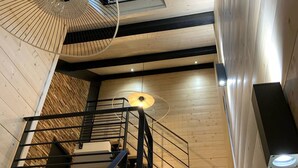 A staircase with a metal railing leading to a wooden floor.