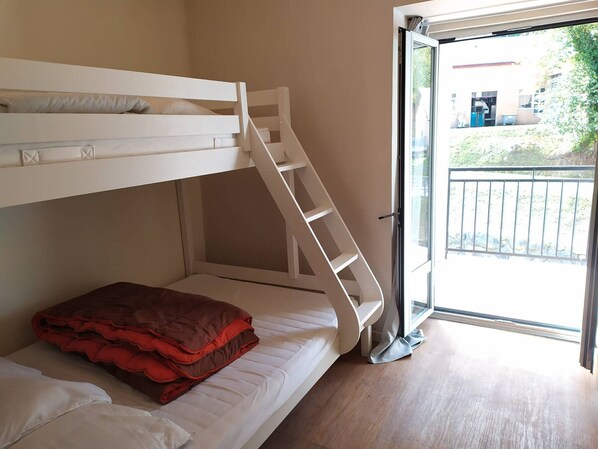 A bunk bed room with a staircase leading to a balcony. - Charming T2 apartment in Cauterets (Cauterets)