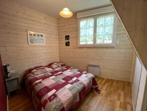 Relax in this serene bedroom with a single bed, bedside table, and radiator for a cozy retreat.