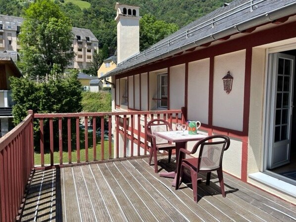 Traditional chalet-style building with a deck and lantern, offering a peaceful retreat.