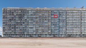 A large, multi-story hotel with a uniform facade, numerous balconies, and a flat roof. - Apartment in Ostend With sea Views (Ostend)