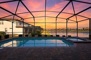 A swimming pool with a view of houses and a body of water. - Themed retreat w/ pool, arcade & resort access (Kissimmee)