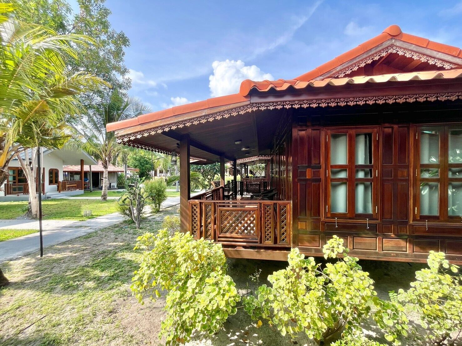 A traditional wooden building with a covered porch and large windows.
