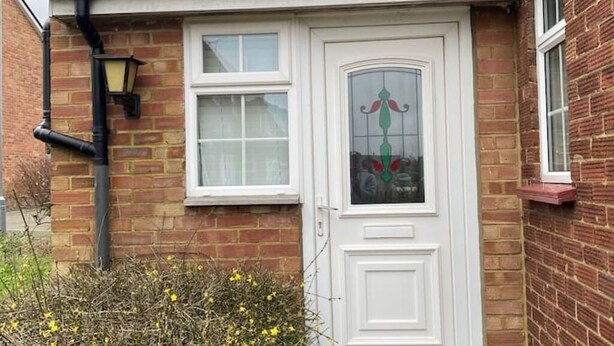 A house with a white door, a window, and a brick wall. - Cosy 1 Bedroom Apartment Private Access in Guildford

 (Guildford)
