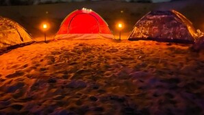 Three tents on a sandy surface with lights inside. - Star view desert camp  (Jaisalmer)