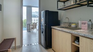 A modern kitchen with a black refrigerator, wooden cabinets, a marble countertop, and a welcome sign. - w Dazzling 2BR w Fantastic Terrace in CTG (Cartagena)