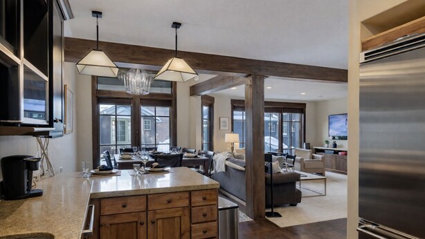 A spacious kitchen with a large island, wooden cabinets, and a stainless steel refrigerator. - Ski Ya Soon At Silver Star! 2 Bedroom Condo (Park City)