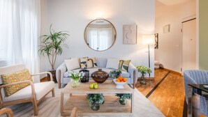 A modern living room with a sofa, coffee table, and decorative plants. - The City Terrace Apartment: smart 2 bedrooms in Lucca (Lucca)