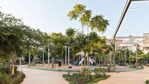 An outdoor recreational area with playground equipment, walking paths, and greenery. - Laia Deluxe Terrace Apartment (Barcelona)