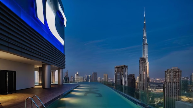 A rooftop pool with a city skyline view, including a prominent skyscraper. - Lux BnB Paramount Ocean View (Dubai)