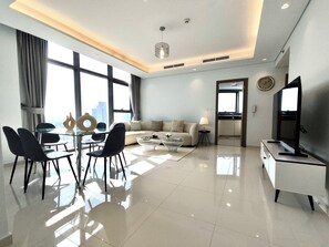 Grand Apartment, Ocean View | Living area | 50-inch Smart TV with cable channels, Netflix, streaming services - Lux BnB Paramount Ocean View (Dubai)