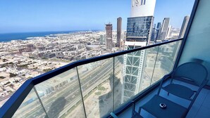 A high-rise building with a view of a cityscape and the ocean. - Lux BnB Paramount Ocean View (Dubai)