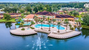 A resort with a large central pool, multiple smaller pools, and a water fountain.