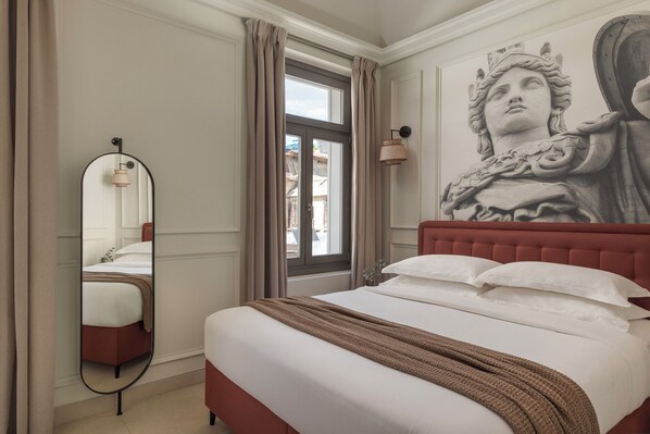 A bedroom with a large bed, a mirror, a window with curtains, and a wall mural. - Airy Suites Athens (Athens)