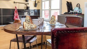 A kitchen with a round table, chairs, and a window.