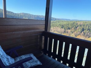 A wooden deck with a bench and a newspaper. - Complete Apartment With own Balcony (Vohenstrauss)