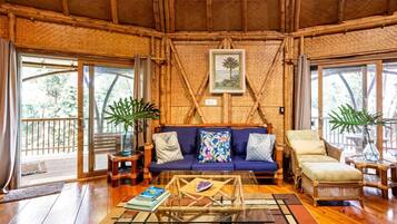 Comfort Cottage, 2 Bedrooms, Hot Tub, Garden View | Living room | 50-inch Smart TV with cable channels, books